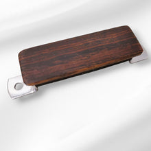 Custom wood string mute for arch top type bridge.