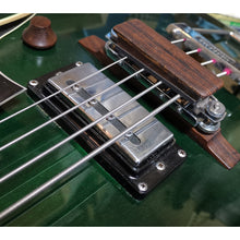 Custom wood string mute for arch top type bridge.