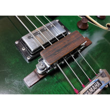 Custom wood string mute for arch top type bridge.